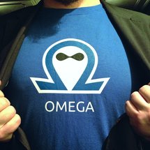 Nico Grienauer is opening his jacket to reveal a omega t-shirt